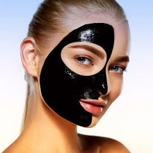 Close-up portrait of attractive girl with black cosmetic mask on her face.